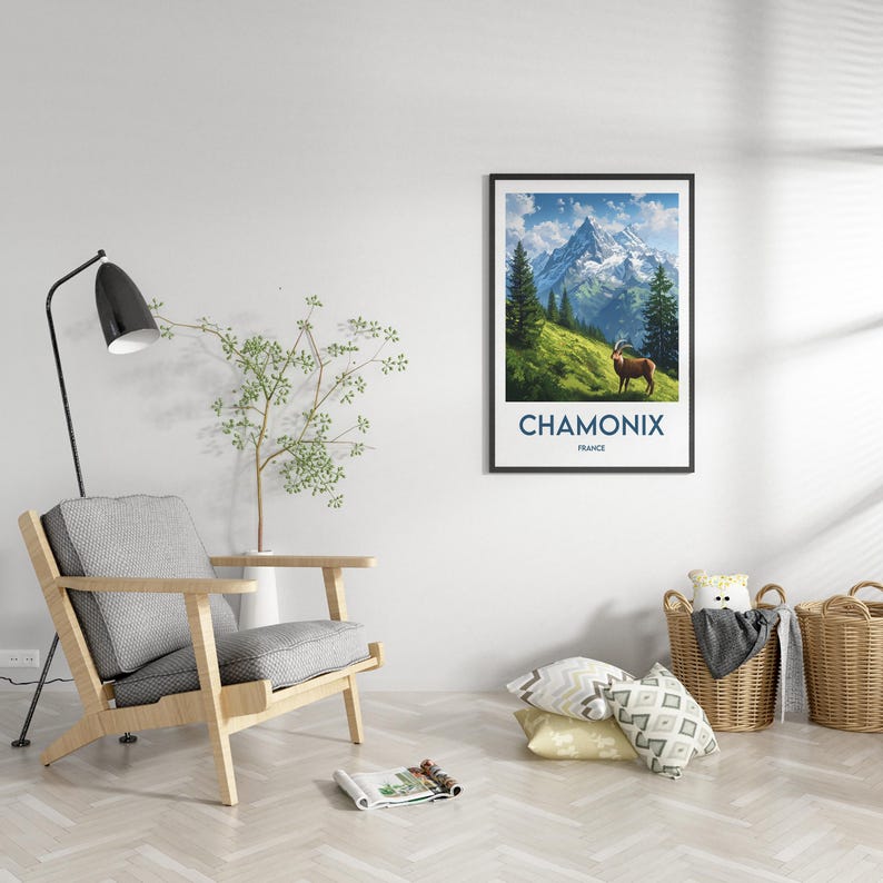 May include: A framed poster depicting a scenic view of a mountain range in Chamonix, France. The poster features a blue sky with white clouds, green trees, and a brown mountain goat standing on a grassy slope. The text "Chamonix, France" is printed below the image.