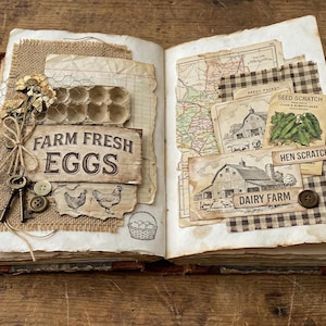 May include: Open book with vintage farm-themed scrapbook pages. Features include a sign that reads "Farm Fresh Eggs", illustrations of chickens, and a basket of eggs. Other pages have maps, seed packets, and barn illustrations.