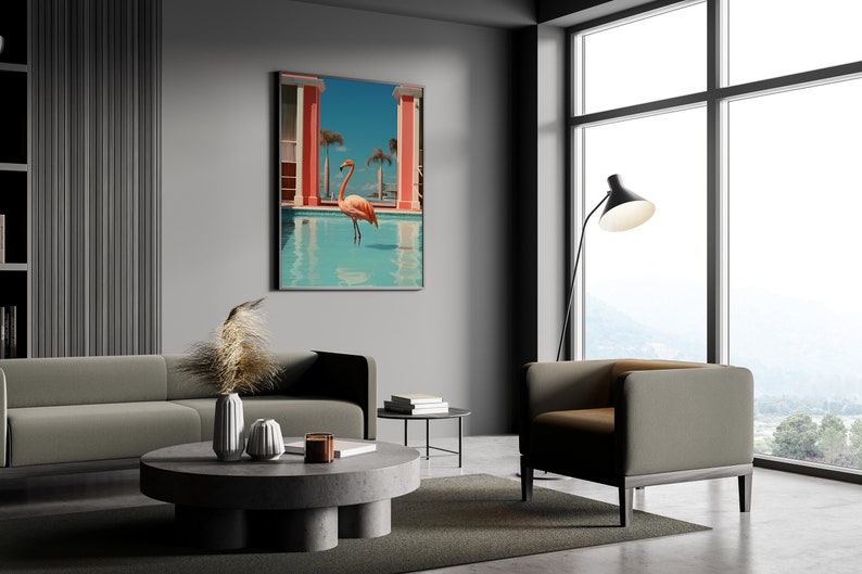 May include: A modern living room interior with a gray sofa, a round coffee table, and a gray armchair. A large framed print of a pink flamingo standing in a pool hangs on the wall. The room has a large window with a view of a mountain range.