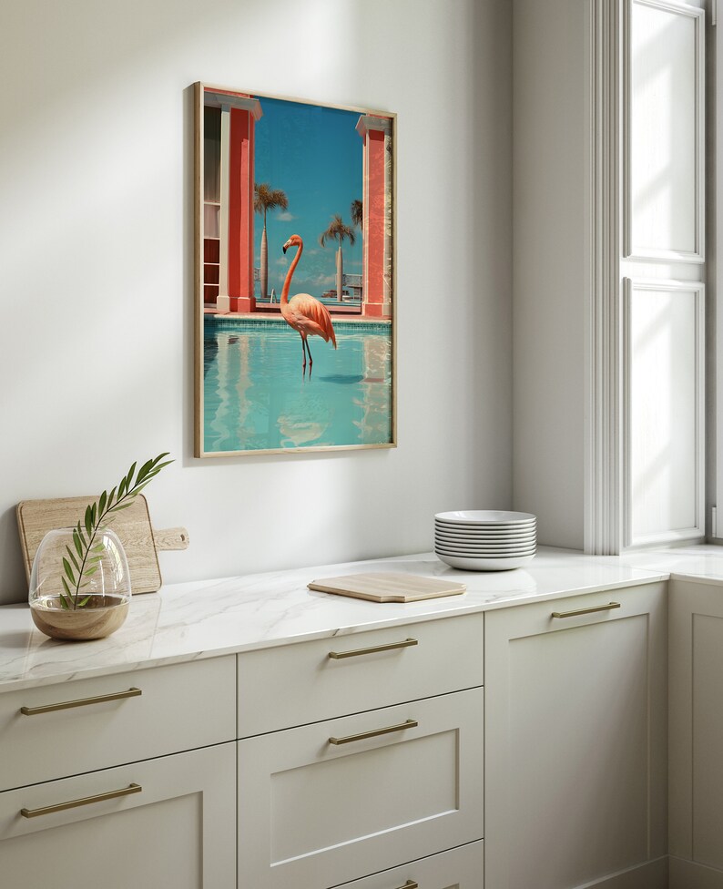 May include: A framed print of a pink flamingo standing in a blue pool with a pink building in the background.