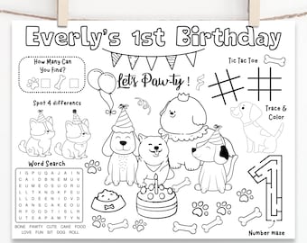 May include: Black and white activity placemat for a dog-themed first birthday party. Features the text "Everly's 1st Birthday" and includes games like a word search, tic-tac-toe, and a number maze. Includes illustrations of dogs, paw prints, and a birthday cake.