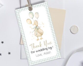 May include: A light blue and white checkered thank you tag with a watercolor illustration of a duck holding balloons. The text reads "Thank You for waddling by! Love, Aidan".