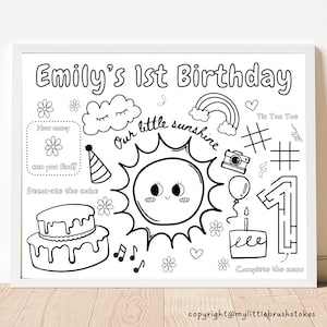 Puede incluir: Hoja de actividades imprimible en blanco y negro para una fiesta de primer cumpleaños. La hoja presenta un sol con cara, un pastel, un laberinto, un tablero de tres en raya y el texto "Emily's 1st Birthday".