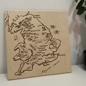 May include: A wood-burned map of Anglo-Saxon England, showing the kingdoms of Northumbria, Mercia, East Anglia, Wessex, and Cornwall. The map includes the names of various cities and towns.