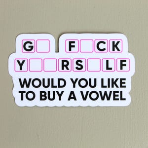 May include: White sticker with black text that reads "G  F  C  K  Y  R  S  L  F  Would you like to buy a vowel?"