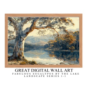 May include: A digital painting depicting a landscape scene with a large eucalyptus tree in the foreground, a lake in the middle ground, and mountains in the background. The sky is a light blue with some clouds. The tree has white bark and its branches reach over the lake. The lake is a light blue with reflections of the sky and trees. The mountains are a dark blue with some green trees on them. The painting is framed in a light wood frame. The text "GREAT DIGITAL WALL ART FABULOUS EUCALYPTUS BY THE LAKE LANDSCAPE SERIES 1-1" is at the bottom of the image.