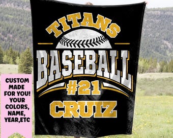 May include: Black fleece blanket with a gold baseball design. The text "TITANS BASEBALL #21 CRUZ" is on the blanket.