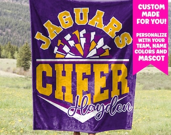 May include: Purple fleece blanket with a yellow and white design that says "Jaguars Cheer Hayden".