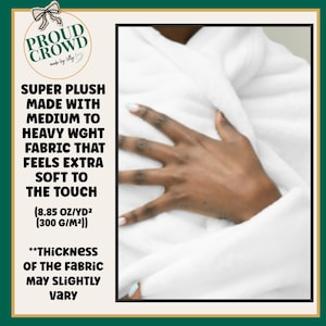 May include: A white plush fabric with a medium to heavy weight of 300 g/m2. The text reads: PROUD CROWD made by Lolly, SUPER PLUSH MADE WITH MEDIUM TO HEAVY WGHT FABRIC THAT FEELS EXTRA SOFT TO THE TOUCH (8.85 OZ/YD2 (300 G/M2)) **THICKNESS OF THE FABRIC MAY SLIGHTLY VARY.
