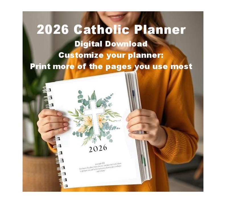 May include: A white spiral-bound 2026 Catholic Planner with a floral cross design. The cover features the year 2026 and text that reads "Digital Download" and "Customize your planner: Print more of the pages you use most."