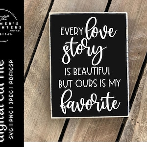 May include: Black wooden sign with white text that reads "Every love story is beautiful but ours is my favorite".