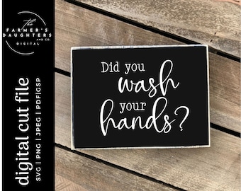 May include: Black sign with white text that reads "Did you wash your hands?" The sign is on a wooden surface.