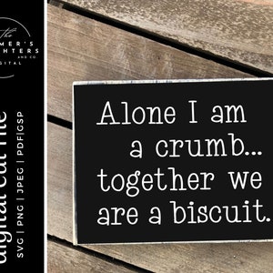 May include: Black and white sign with the text "Alone I am a crumb... together we are a biscuit."