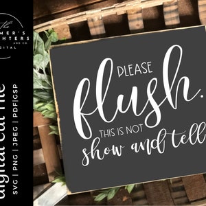 May include: A black sign with white text that reads "PLEASE flush THIS IS NOT show and tell."