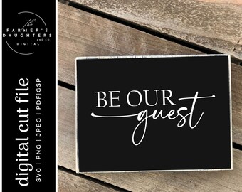May include: Black wooden sign with white text that reads "BE OUR guest" in a cursive font.
