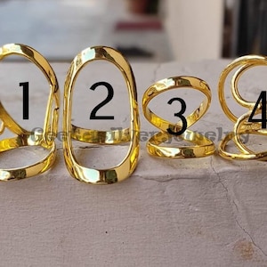 May include: Four gold-colored rings, each with a different design. The rings are numbered 1 through 4.