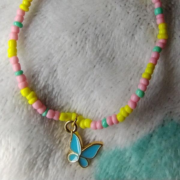 Yellow and pink seed bead bracket with butterfly
