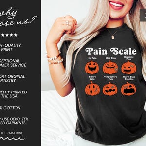 May include: A black t-shirt featuring a graphic titled Pain Scale with six orange jack-o'-lantern pumpkins displaying different facial expressions. The text labels include No Pain, Mild Pain, Moderate Pain, Severe Pain, Very Severe Pain, and Worst Pain Possible.