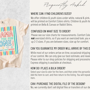 May include: Cream-colored t-shirt with a colorful graphic that reads "MAMA OF THE FUN ONE" with "OLIVER'S FIRST BIRTHDAY" below. The design features vertical stripes in red, blue, green, and yellow.