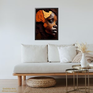 May include: A framed print of a woman's face with abstract makeup in shades of orange and brown. The makeup design resembles the shape of the continent of Africa.