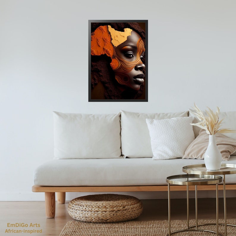 May include: A framed print of a woman's face with abstract makeup in shades of orange and brown. The makeup design resembles the shape of the continent of Africa.
