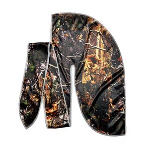 May include: A satin durag with a camouflage pattern in shades of brown, green, and orange. The durag has a white trim.