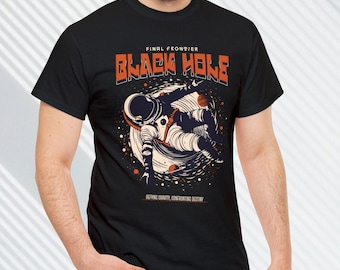May include: Black t-shirt with a graphic of an astronaut floating in space with the text "FINAL FRONTIER BLACK HOLE DEFYING GRAVITY, CONFRONTING DESTINY".