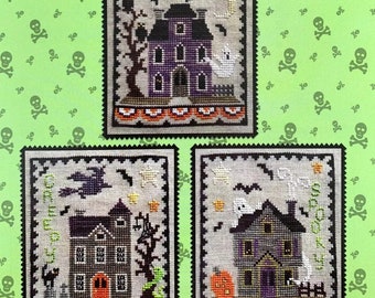 May include: A cross-stitch pattern sheet titled Waxing Moon Designs Haunted House Trio featuring three rectangular designs on a light green background with skull motifs. Each design depicts a dark house with ghosts, bats, and pumpkins.
