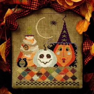 May include: A cross-stitch pattern titled "The Cricket Collection" features a Halloween theme. The design includes a witch, a smiling pumpkin, and a stack of treats. The text "A Wicked Patch" and "designed by Vicki Hastings" are also visible.