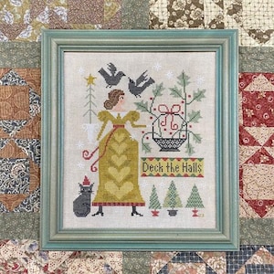 May include: A framed cross-stitch chart titled "Deck the Halls" with a woman in a yellow dress, birds, and Christmas trees. The chart is surrounded by a patchwork border and includes the text "Teresa Kogut's Creative Whims."