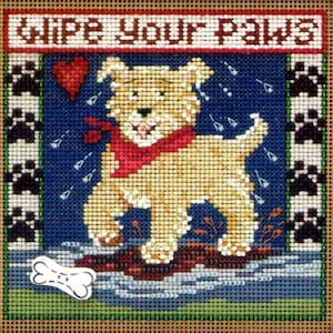 May include: A cross-stitch pattern featuring a cute cartoon dog with a red bandana, walking through a puddle with the text "Wipe Your Paws" above it.