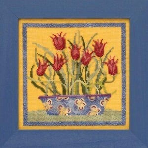 May include: Cross-stitch artwork of red tulips in a blue patterned pot, set against a yellow background. The artwork is framed in a blue wooden frame, creating a vibrant and decorative piece.