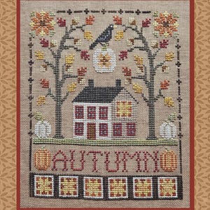 May include: A cross-stitch embroidery on tan fabric featuring a house with a dark roof, two trees with red and yellow leaves, a black bird, white and orange pumpkins, and the word AUTUMN in red letters above a row of five yellow and red squares.