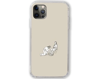 May include: A clear phone case with a beige background and a black and white illustration of two people washing feet in a basin.