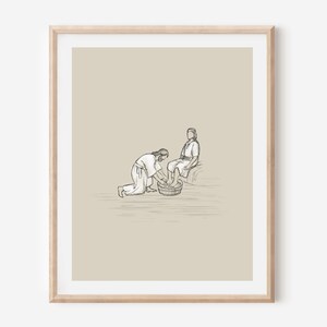May include: A black and white line drawing of two people. One person is kneeling and washing the other person's feet in a basin.