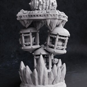 May include: A detailed, gray 3D-printed sculpture of a fantastical structure. It features a central tower with suspended cages and a complex, gear-like top. The base is a rocky formation, and the overall design suggests a fantasy or steampunk theme.