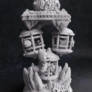 May include: A gray 3D-printed sculpture featuring characters and elements from the Mario Bros. video game series. The sculpture includes cages, a bridge, and a large gear-like structure, all set on a rocky base with the Mario Bros. logo.