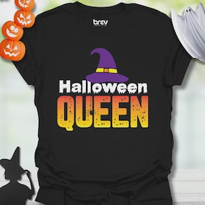 May include: Black t-shirt with a Halloween-themed design. The design features the words "Halloween QUEEN" in white and yellow-orange gradient font, with a purple witch hat and a spider. The shirt is a crew neck.