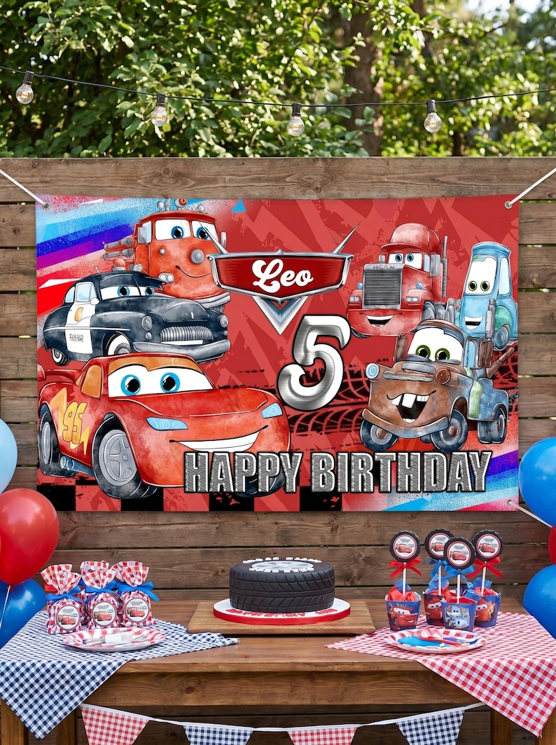 May include: A birthday party scene with a banner featuring Cars characters, the name "Leo", and the number "5". The table is set with a cake, cupcakes, and party favors. Red, blue, and white decorations create a festive atmosphere.