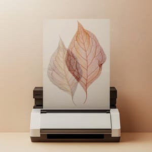 Pode incluir: Uma impressão em aquarela de duas folhas em tons de pêssego e bege, exibida em uma impressora branca. As folhas têm detalhes delicados de veias e estão em um fundo neutro.