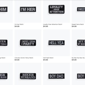May include: Collection of black and white embroidered patches with various phrases, including "I'm Him," "I'm Her," and "Sweet Yams." These patches are rectangular and designed for clothing or accessories.