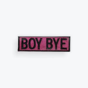May include: A rectangular patch with the words "BOY BYE" in black block letters on a pink background. The patch has a black border and is centered on a white background.