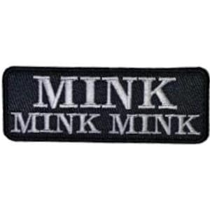 May include: A rectangular black embroidered patch with rounded corners. The word MINK is stitched in white capital letters on the top line, and the words MINK MINK are stitched in white capital letters on the bottom line of the patch.