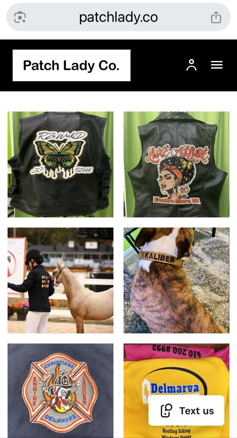 May include: A selection of patches and clothing from Patch Lady Co. Features a black leather vest with a butterfly motif, a vest with a woman's face, a dog collar, a firefighter patch, and a Delmarva shirt. The website address is patchlady.co.