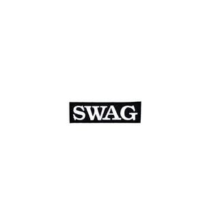 May include: A black rectangular patch with the word "SWAG" in white, bold, capital letters. The patch is centered on a white background. The patch is likely for clothing or accessories.