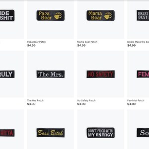 May include: Collection of black rectangular patches with white or gold text. Phrases include "I Ride My Shit," "Papa Bear," "Mama Bear," "Bikers Make the Best Lovers," "Unruly," "The Mrs.," "No Safety," "Feminist," "Real Hitta," "Boss Bitch," "Don't Fuck With My Energy," and "Soror."