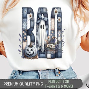 May include: White t-shirt featuring a Halloween-themed graphic. The design spells "BOO" with patchwork letters, a ghost, a jack-o'-lantern, and floral accents. The text "PREMIUM QUALITY PNG" and "PERFECT FOR T-SHIRTS & MORE!" are also visible.