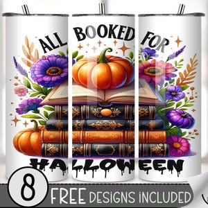 May include: White tumbler with a Halloween design. The design features an open book topped with an orange pumpkin, surrounded by purple and pink flowers. The text reads "ALL BOOKED FOR HALLOWEEN".