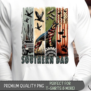 May include: White long-sleeve shirt with a graphic design featuring a German Shepherd dog with an American flag pattern, ducks, bullets, and a truck. The text "SOUTHERN DAD" is below the design.