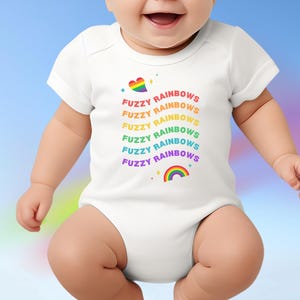 May include: White baby bodysuit with the text "Fuzzy Rainbows" in a rainbow color scheme. The design includes a heart with a rainbow and a rainbow graphic. The baby is wearing the bodysuit.